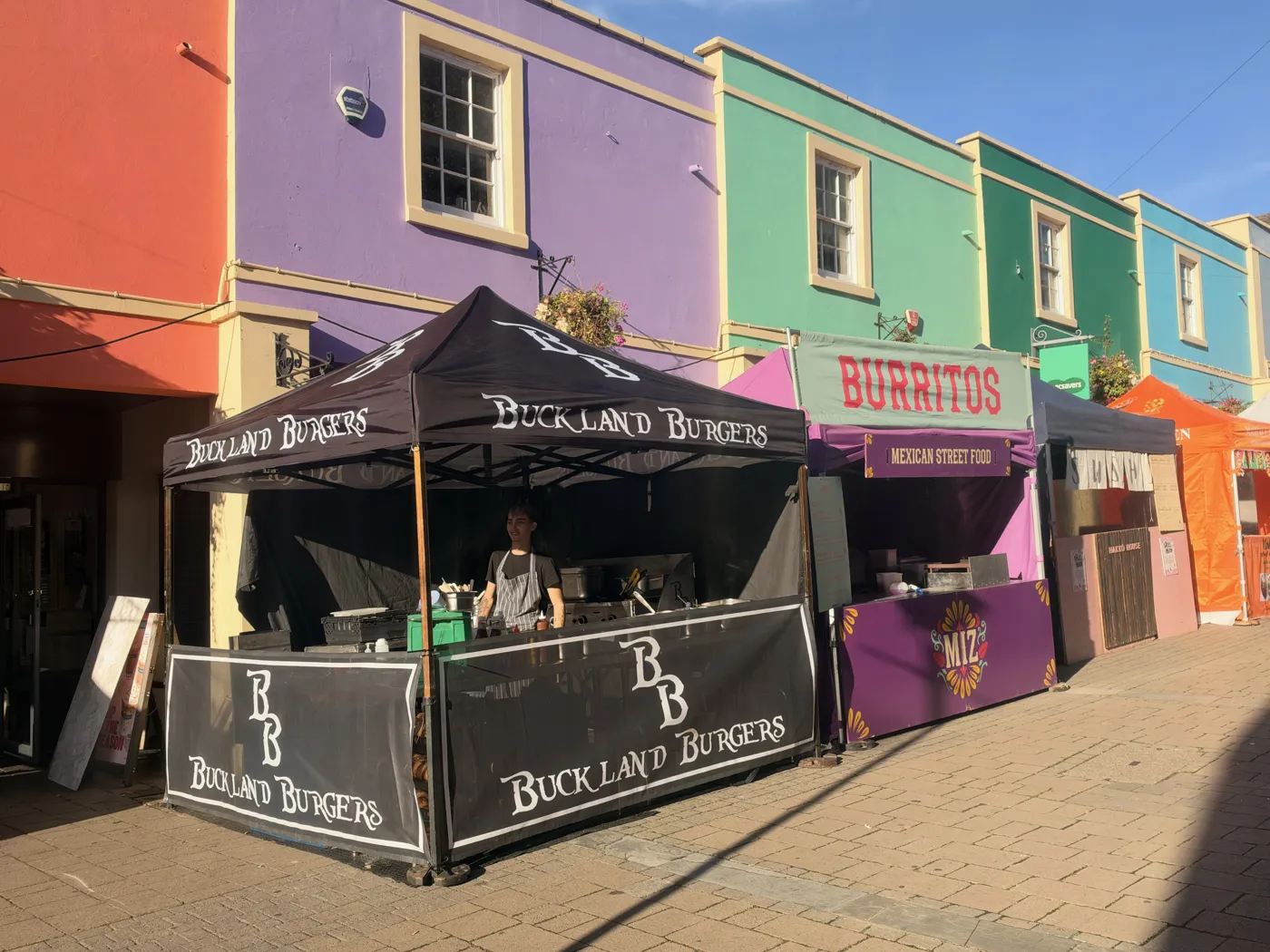 The Buckland Burgers gazebo on a street of colourful houses